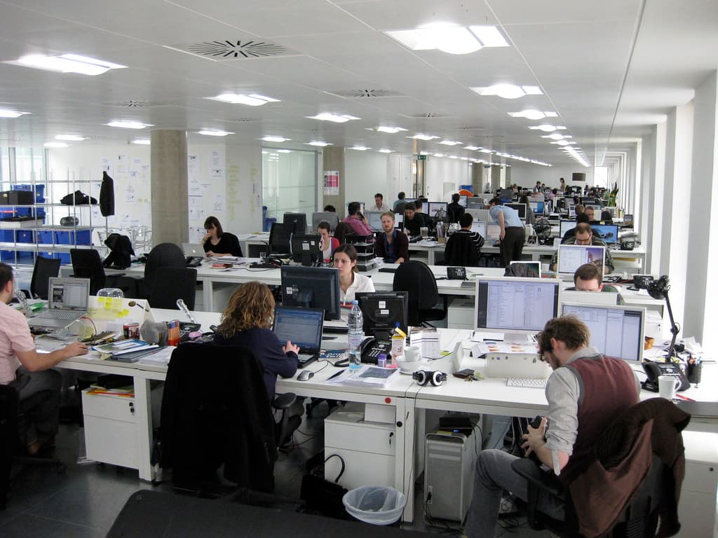 A team reviewing customer data on a CRM dashboard in a modern office
