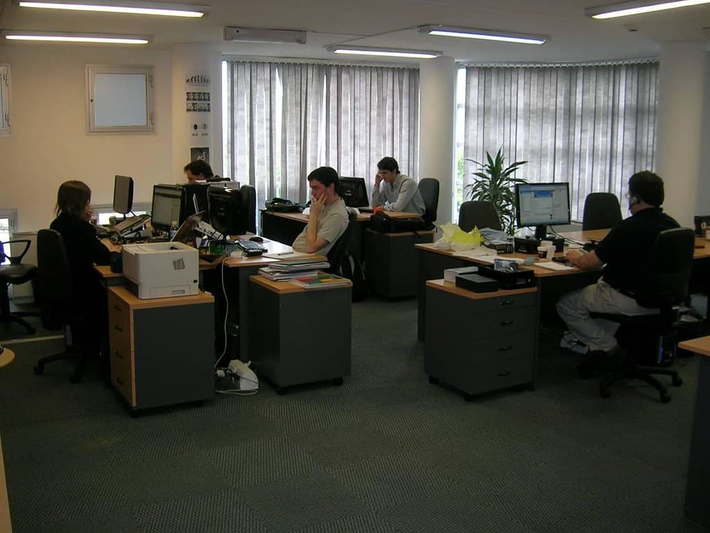 A sales team reviewing customer data on a CRM dashboard in a modern office