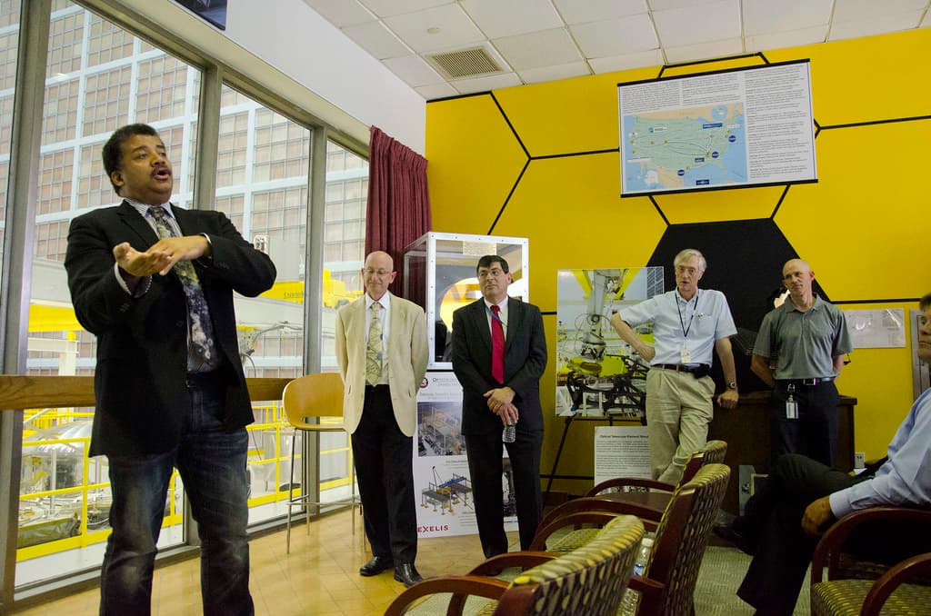 A sales team reviewing customer data on a CRM dashboard in a modern office